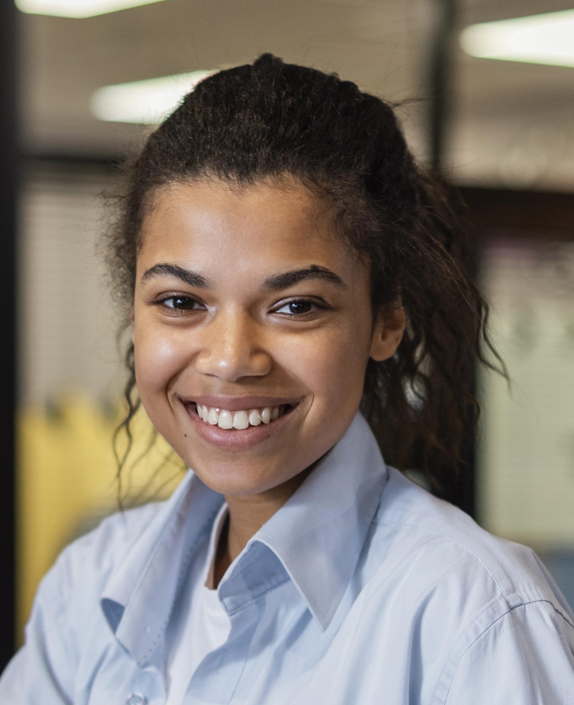 smiley-woman-working-with-laptop-papers-office-min